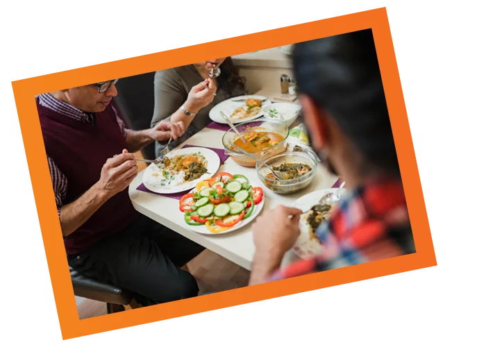 Cozy dining scene with friends enjoying colorful, flavorful dishes in an inviting atmosphere.