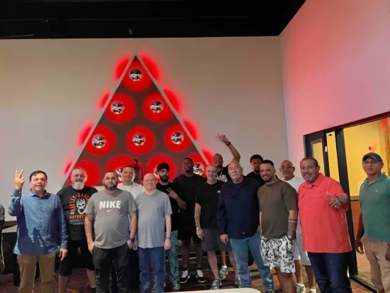 Men celebrating together in a festive setting with vibrant decorations and joyful expressions.